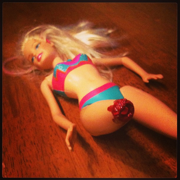 Surfer Barbie's leg broke so instead of throwing her away I turned her into Shark Attack Barbie! G can't wait to play with her... We just have to wait for the glittery Barbie blood to dry.